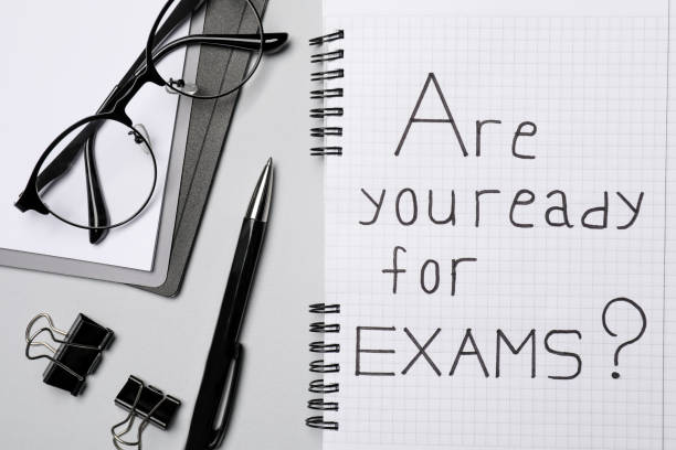 istock Notebook with question Are you ready for exams and stationery on grey table, flat lay 1488432996