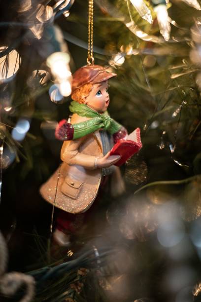 istock Cheerful young boy's Christmas decoration on a tree adorned with colorful decorations 1488436487