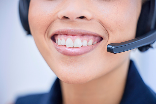 Call center, teeth and smile with mouth of black woman for telemarketing, customer support and receptionist. Happy, communication and consulting with employee  for advisor, service and help desk
