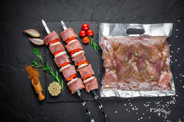 vacuum-packed grilled meat, on a dark background. - airtight packing meat food imagens e fotografias de stock