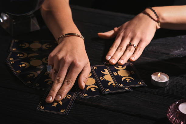 istock Soothsayer predicting future with tarot cards at table in darkness, closeup 1488438504