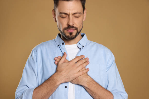 istock Man with clasped hands praying on beige background 1488438594