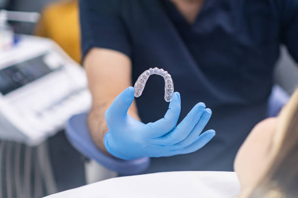 istock Professional orthodontist showing innovative aligners to camera designed for bite correction 1488439730