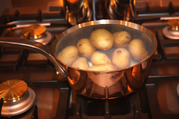 istock Boiled potatoes in a copper pan on a gas hob 1488441591
