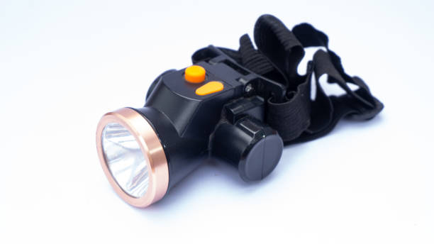 istock A black headlamp with a copper crown and an orange rubber button 1488442438