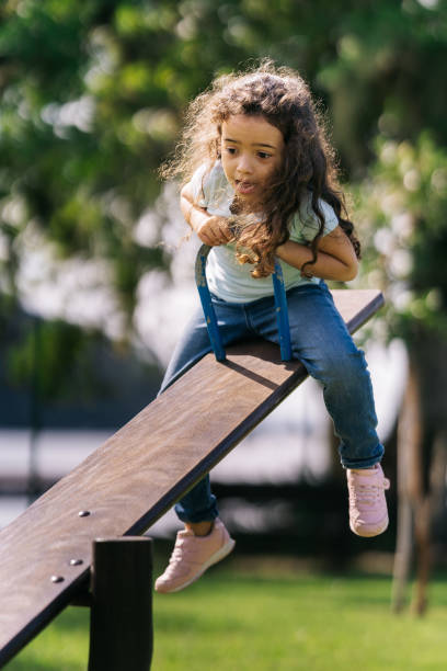 istock Scared girl on seesaw 1488442629