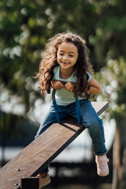 istock Girl having fun on the seesaw 1488442634