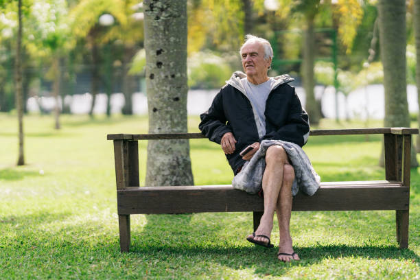 istock Elderly man relaxing on park bench 1488442705
