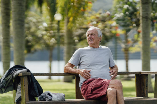 istock Retired man relaxing on park bench 1488442706