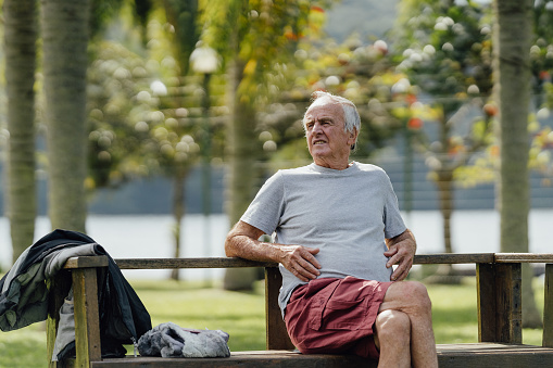 Retired man relaxing on park bench