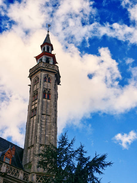 istock Church bell tower in cloudy sky, Bruges, Belgium 1488443869