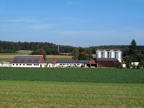 Farmhouse with solar panels on roof.