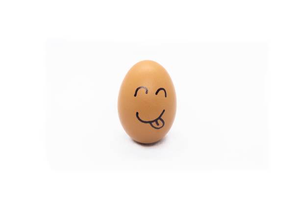 istock an egg with a smiling face on top of it sitting on the ground 1488444673