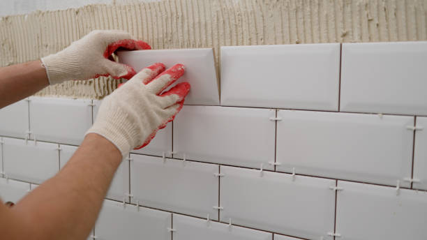 istock Tile apron in the kitchen. White tiles, leveling clips, tile cement. Laying backsplash tiles in the kitchen. 1488447132
