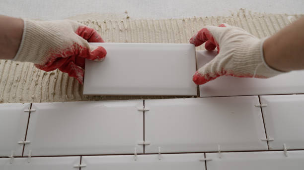 istock Tile apron in the kitchen. White tiles, leveling clips, tile cement. Laying backsplash tiles in the kitchen. 1488447136