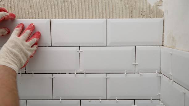 istock Tile apron in the kitchen. White tiles, leveling clips, tile cement. Laying backsplash tiles in the kitchen. 1488447154