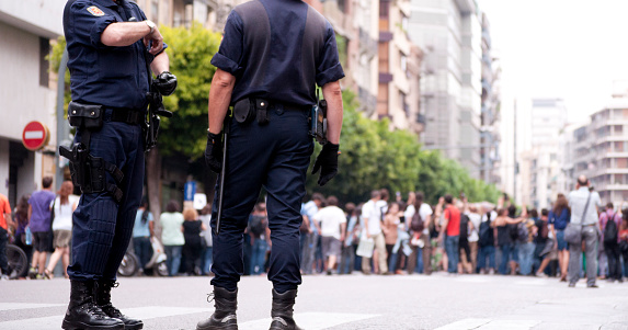 Seville, Spain -- June 6, 2022. Police Officers guard the route as people gather for the Corpus Christi procession.