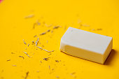 White eraser on a yellow background. Rubbish from erasure.