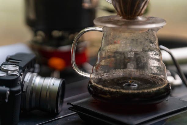 istock a selective focus on coffee brewer and coffee pot with camera, grinder, stove in the background 1488454994