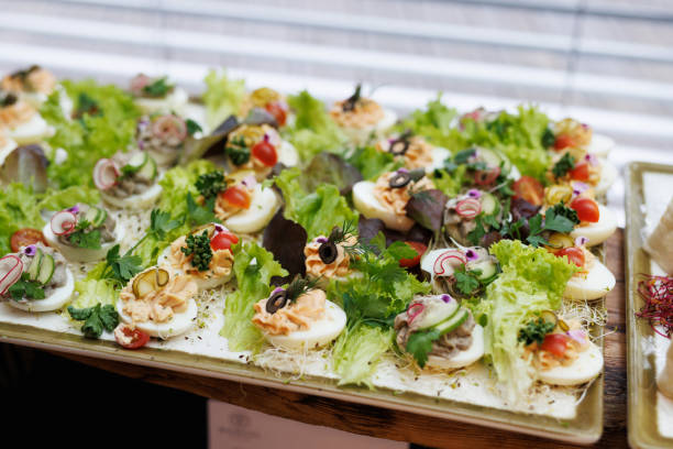 istock Boiled egg halves with mayonnaise and green onions at the buffet. 1488455135