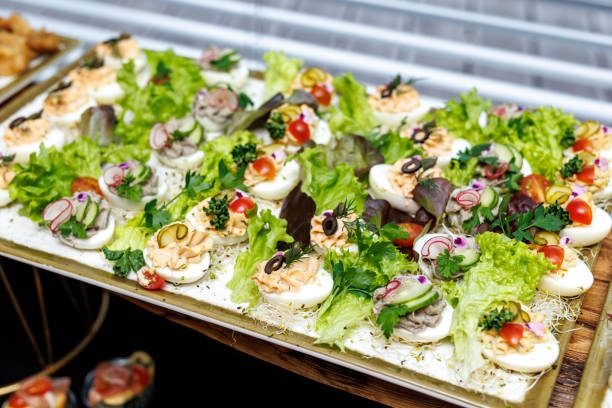 istock Boiled egg halves with mayonnaise and green onions at the buffet. 1488455138