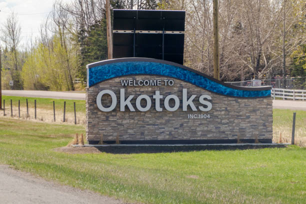 una señal de bienvenida a la ciudad de okotoks. una ciudad en la región de calgary de alberta, canadá. está en el río sheep, aproximadamente a 18 km al sur de calgary. - okotoks fotografías e imágenes de stock