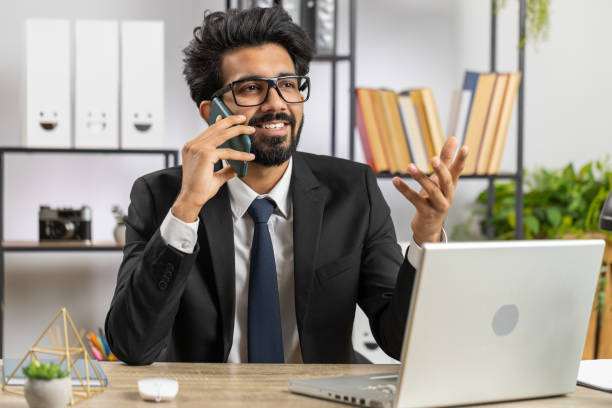 istock Indian business man working, having mobile phone talk at office workplace using messenger chat apps 1488458563
