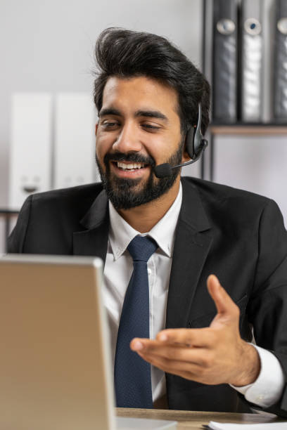 istock Businessman working on laptop wearing headset, call center support service operator office helpline 1488459092