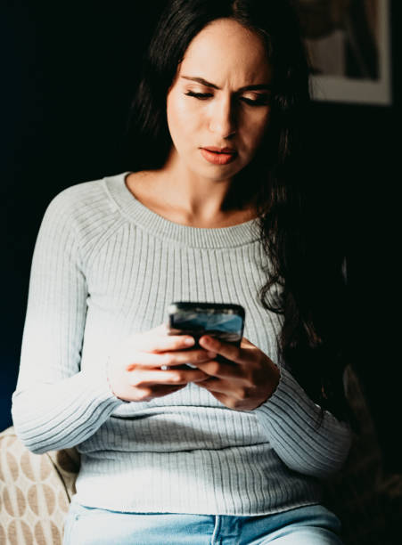 istock Worried woman with stress looking at her phone with concern 1488463364