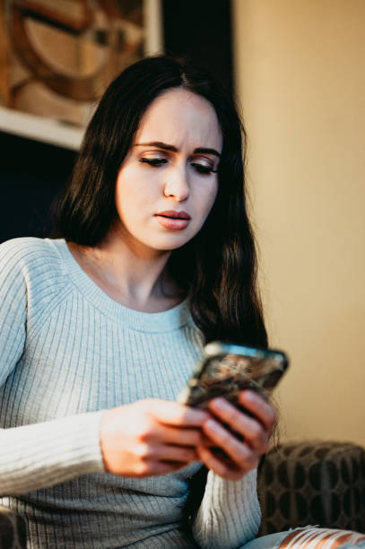 istock Worried woman with stress looking at her phone with concern 1488463368