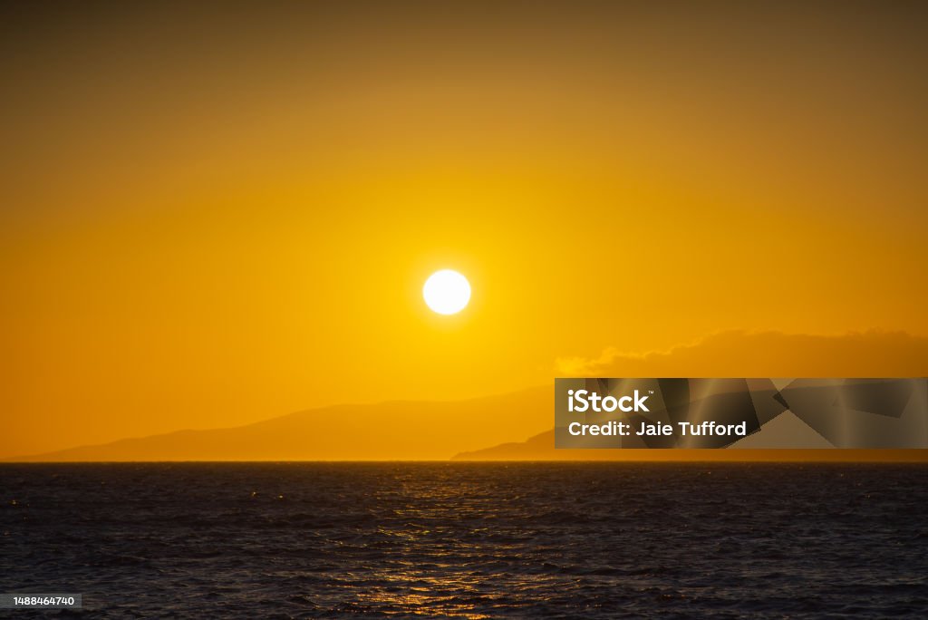 Maui Sunset Sunset over Mountains and Sea Maui Hawaii Beach Stock Photo