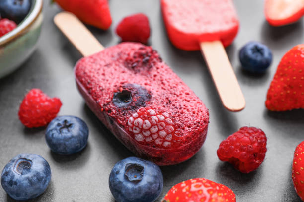 istock Tasty berry ice pops on dark table, closeup. Fruit popsicle 1488464996