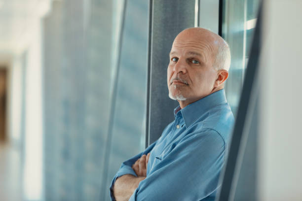 istock Smart man with folded arms in modern corporate facilities 1488466812