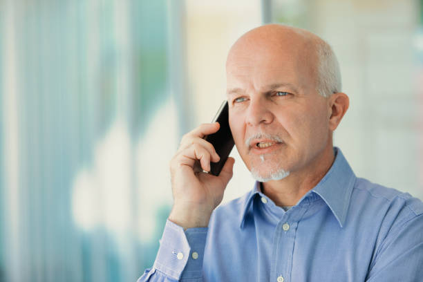 istock old man phones with a mobile phone 1488466973