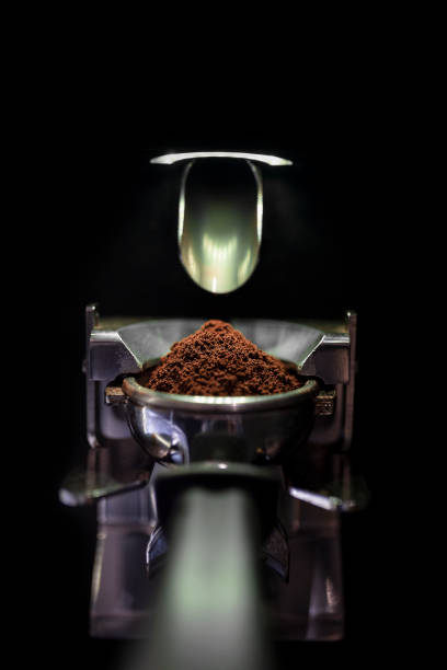 Coffee beans grounded to fine consistency for an espresso shot. Espresso machine to make cappuccinos, lattes, and fine coffee drinks