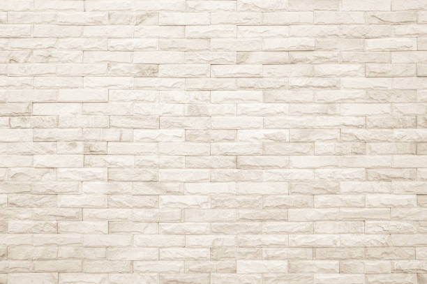 istock Empty background of wide cream brick wall texture. Beige old brown brick wall concrete or stone textured, wallpaper limestone abstract. Cream and white brick wall. Brickwork flooring pattern design. 1488468385