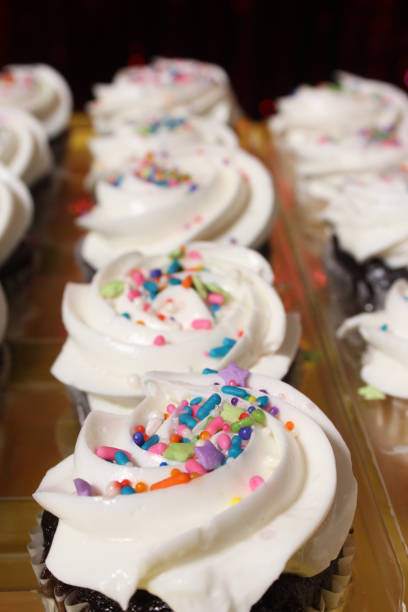 istock Cupcakes with Sprinkles on Table at Birthday Party 1488469778