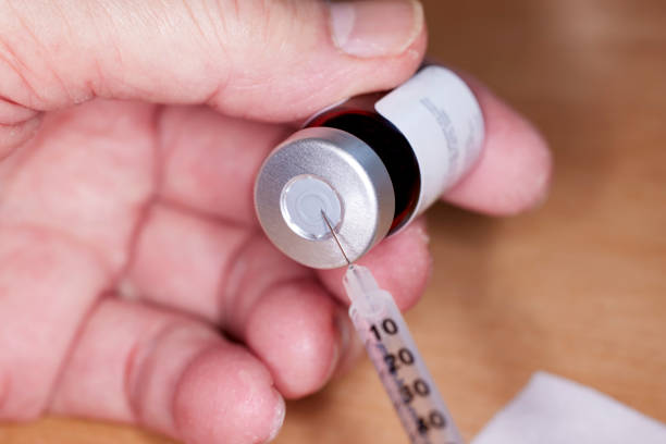 istock Close up of handheld   needle and syringe with Testosterone Vial 1488475010