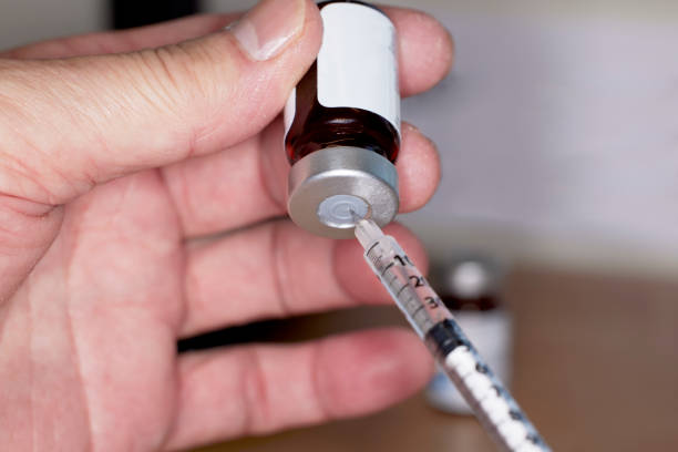 istock Close up of handheld   needle and syringe with Testosterone Vial 1488475065