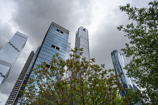 Skyscraper close-up. A low angle view. White clouds in the sky. Low angle shot of Skyscrapers with white clouds background. Chicago, Illinois