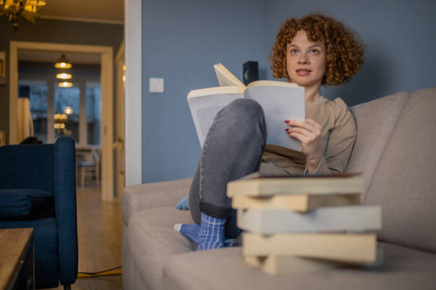 istock Woman relaxing and reading a book 1488475895