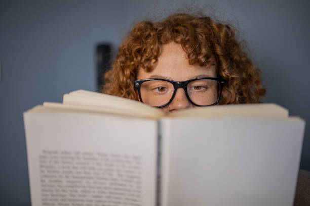 istock Woman relaxing and reading a book 1488475901