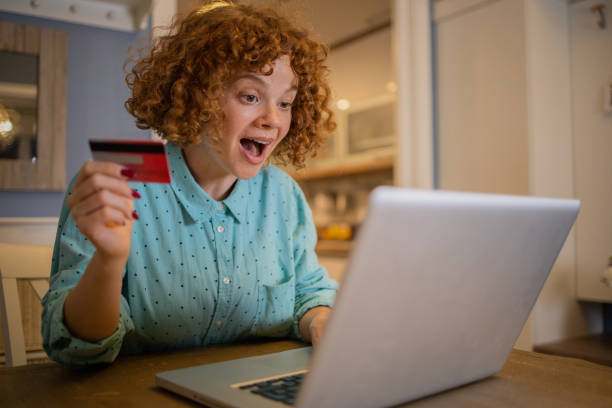istock Cheerful  woman doing online shopping 1488476052
