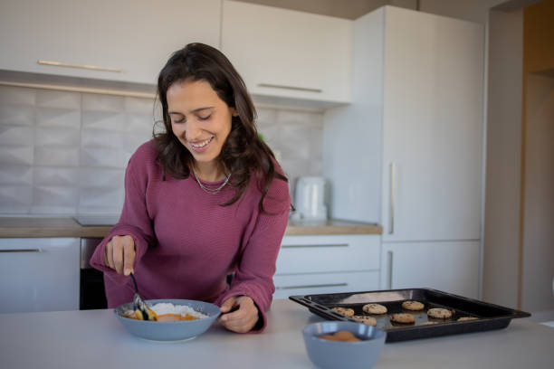 istock Young woman making cookies 1488476748