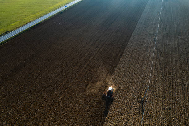 istock farmer driving a crawler tractor ploughing and power harrowing surface crust breaking to facilitate the birth and seeding of plants on dry soil 1488477597