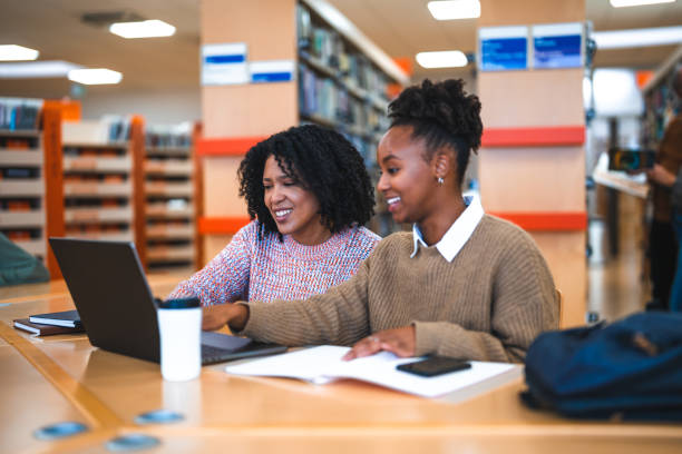 istock Hispanic Females Using Laptop In A Library 1488481079