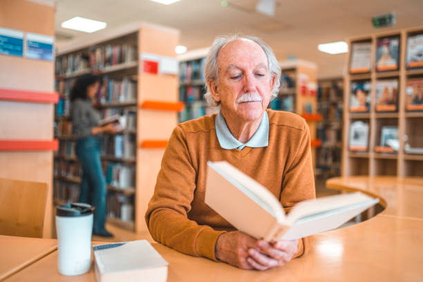 istock Senior Caucasian Reading In A Library 1488481110