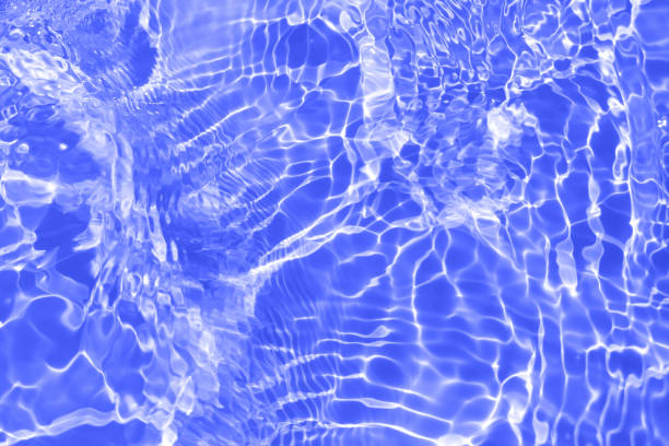 istock Blue water with ripples on the surface. Defocus blurred transparent blue colored clear calm water surface texture with splashes and bubbles. Water waves with shining pattern texture background. 1488481431