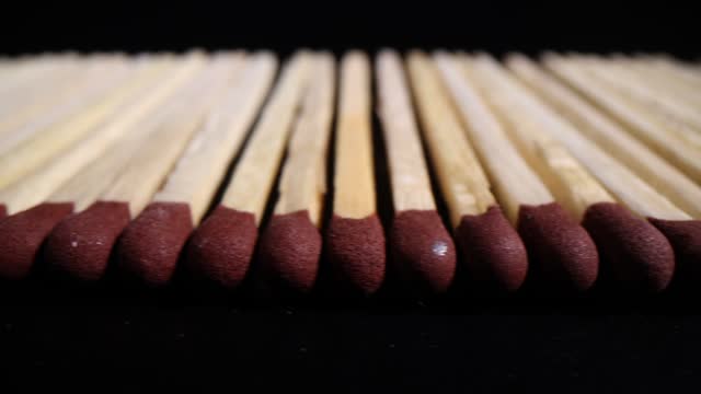 Thin aspen matches with red sulfur head arranged in line