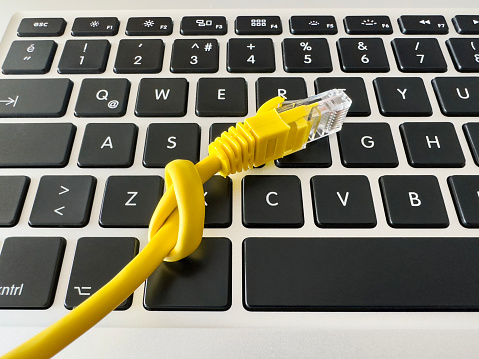 Knotted ethernet cable on a laptop keyboard